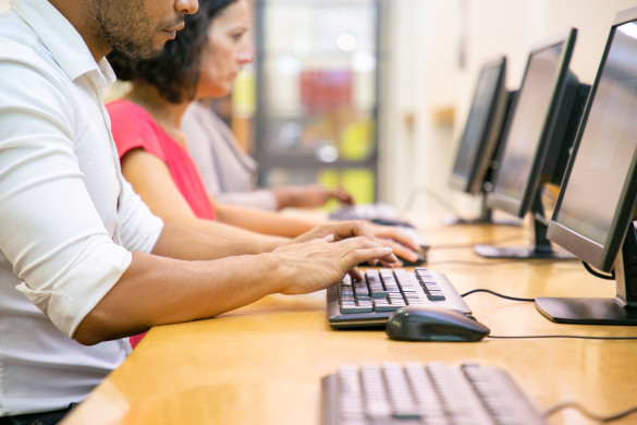 Two people behind computers